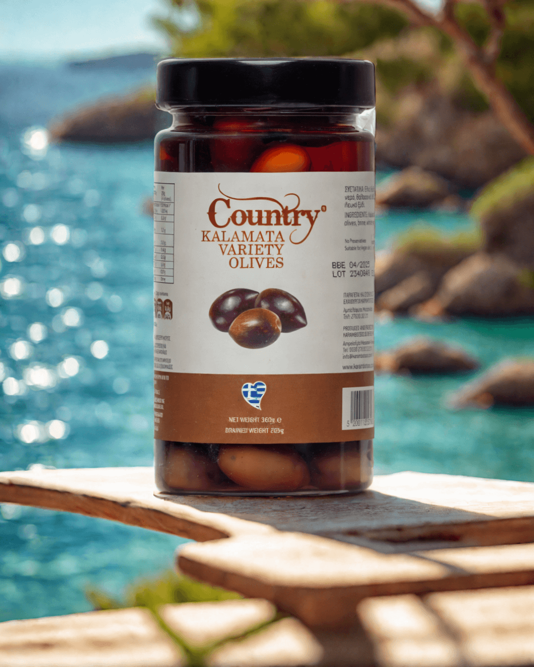 Country Kalamata olives in extra virgin olive oil, ideal for salads and appetizers, packed in a glass jar for freshness.