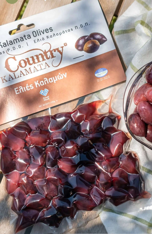 Vacuum-packed Country Kalamata olives, handpicked for rich flavor, ideal for salads and Mediterranean dishes.